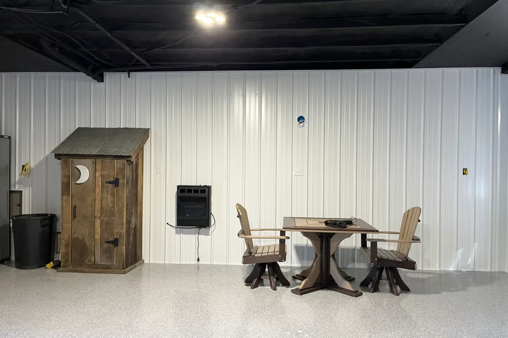 Interior wall with white liner panel and rustic wooden furniture